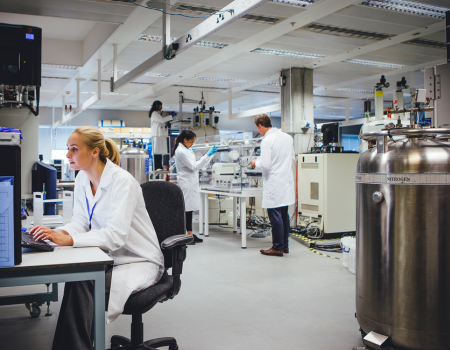 Woman in lab next to liquid nitrogen