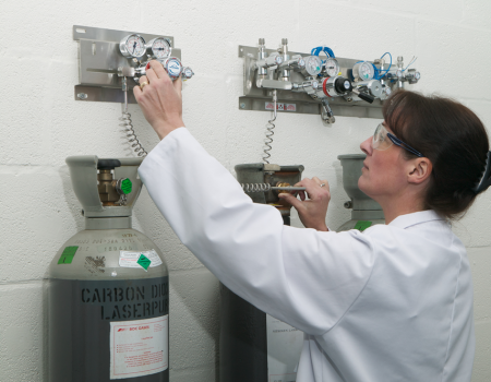 Woman inspecting manifold system in university