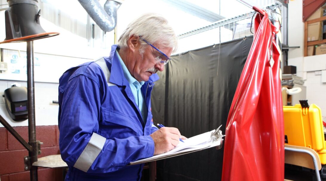 Man with clipboard taking a risk assessment