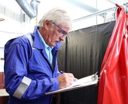 Man with clipboard taking a risk assessment